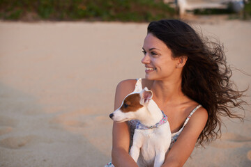 Woman, dog and beach relax for holiday bonding or vacation adventure, explore or morning. Female person, wind and Jack Russell pet or outdoor together for seaside break for view, weekend or peaceful
