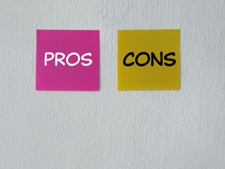 Opinion and ideas concept. PROS and CONS written on adhesive papers. With white blurred vintage styled background.