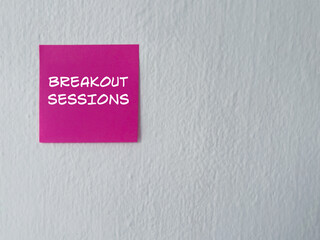 Job and management concept. BREAKOUT SESSIONS written on adhesive paper. On blurred white background.