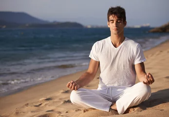 Foto op Plexiglas Meditation, lotus and man on beach, mindfulness and zen with fresh air for calm and eyes closed outdoor. Ocean, seashore and travel with yoga for health, peace of mind and holistic healing for aura © peopleimages.com