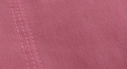 Close up of pink fabric texture with seams. Abstract background and texture for design.