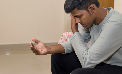young sad and depressed Indian man looking the ring concept of breakup