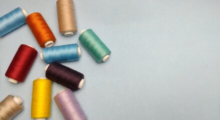 spools of thread on a blue background. place for text.