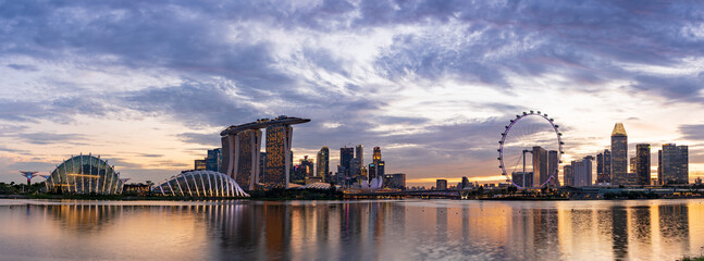 Wide panorama of CBD area in Singapore at dusk.