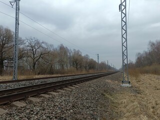 Two way railroad tracks in countryside. Two railway tracks. Cloudy day. Countryside. Fields and...
