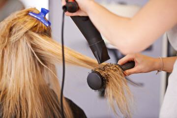 Brush, hair and hands with dryer for beauty, people at hairdresser for haircare and maintenance...