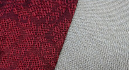 Texture, background, pattern. The fabric is red with a pattern of geometric figures. This is a detailed close-up of the fabric.