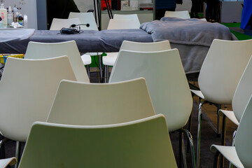 A row of neatly arranged chairs. There is an empty vanity chair in the background. Revenge for training cosmetologists.
