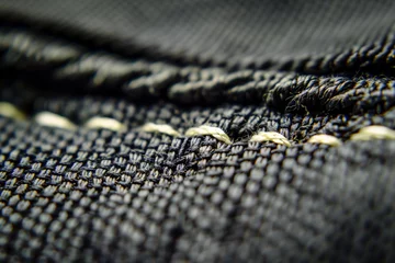 Fotobehang macro shot of interlocking stitches on stretch fabric seam © studioworkstock