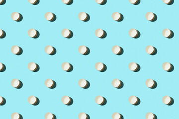 Pattern of cracked eggs, easter concept. Broken chicken eggs on a blue background. Top view, easter concept