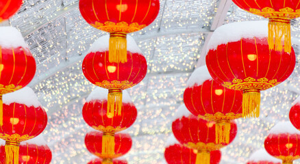 Red lanterns in the snow in the park. Chinese New Year holiday - 768591837