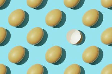 Egg pattern, raw chicken eggs on a blue background with one broken egg. Top view, hatched chick, cracked eggshell, easter concept
