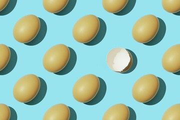 Egg pattern, raw chicken eggs on a blue background with one broken egg. Top view, hatched chick,...