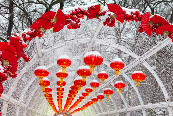 Red lanterns in the snow in the park. Chinese New Year holiday - 768591875