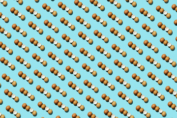 Egg pattern, raw chicken eggs on a blue background with broken eggs. Top view, hatched chick,...