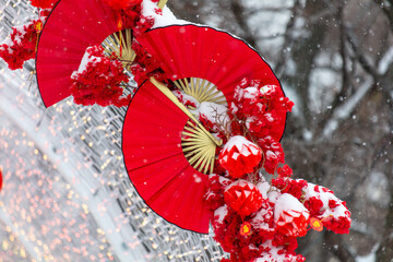 Red fans in the snow in the park. Chinese New Year holiday - 768592025