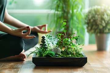 Foto op Plexiglas person in meditation posture beside a small desktop zen garden © studioworkstock