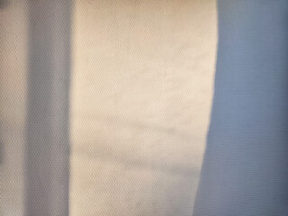 Soft Shadow of a Window Frame Cast on a White Wall. Partial focus, blurred picture. Background, texture, pattern, frame, place for text