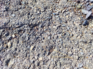 Stone asphalt texture of road. Grey asphalt road and gravel. Background pebble and gravel