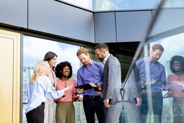 Business Professionals Engaging in a Strategy Discussion Outside a Modern Office Building - 768597428