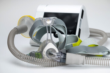 Continuous positive airway pressure system includes of CPAP machine, mask, tube on white background.