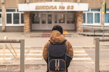 Child boy with bag go to elementary school. Child of primary school.