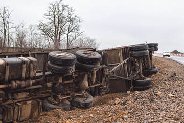 The large truck lies in a side ditch after the road accident