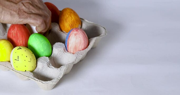 Colored Easter eggs and few white ready for dye, close up