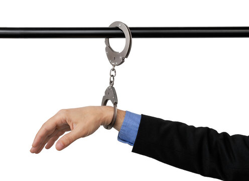 businessman's hand handcuffed to a pipe, anti-corruption concept, cut out on isolated background.