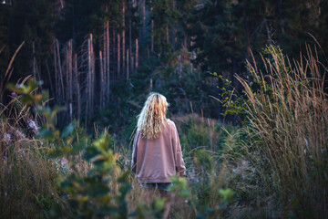 Young Blonde Girl Alone in Dark Forest - 768609802