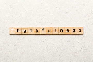 Thankfulness word written on wood block. Thankfulness text on cement table for your desing, concept