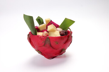 Beautiful Mangosteen mango dragon fruit cube fruit salad in dragon fruit skin bowl on white background - 768620043