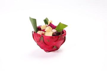 Beautiful Mangosteen mango dragon fruit cube fruit salad in dragon fruit skin bowl on white background