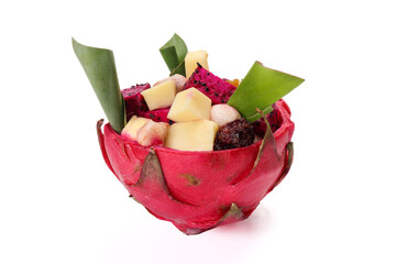 Beautiful Mangosteen mango dragon fruit cube fruit salad in dragon fruit skin bowl on white background