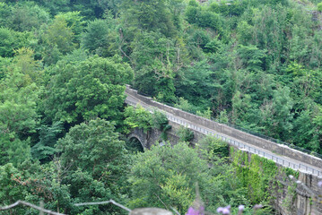 Old Stone Bridge across Deep Wooded Valley seen from Above 