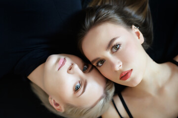 Top view of two young women on a light background. - 768634492