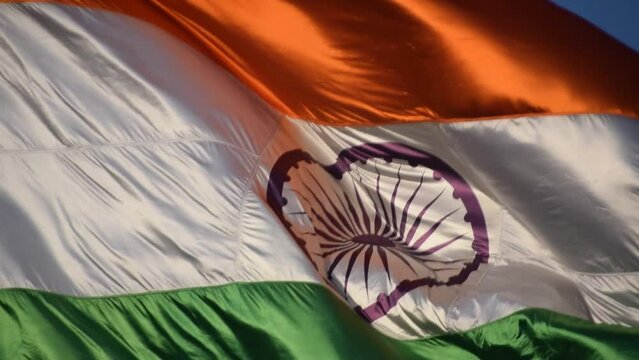 India flag flying high at Connaught Place with pride in blue sky, India flag fluttering, Indian Flag on Independence Day and Republic Day of India, tilt up shot, Waving Indian flag, Har Ghar Tiranga