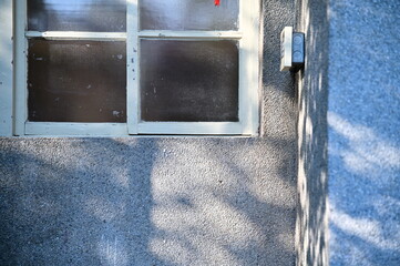 An exposed aggregate finish wall, reminiscent of times past, stands bathed in the warm glow of the...
