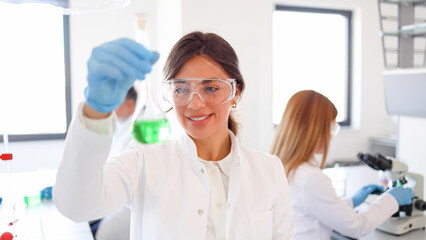 Female scientist mixing some chemicals