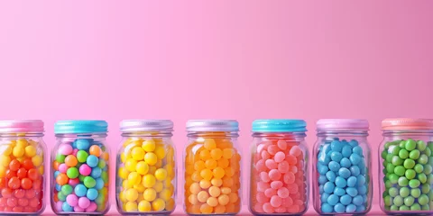Keuken spatwand met foto Colorful candy jars on a table on bright colorful pastel background. © MNStudio