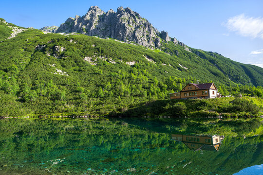 Mountain cottage reflecting in the lake. Chata pri Zelenom plese in High Tatras mountains, Slovakia