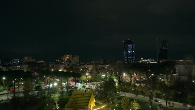 Tirana, Albania - November 27, 2023: Illuminated streets and traffic at night viewed from atop the iconic Tirana Pyramid