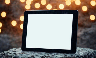 Tablet with white screen on stone background