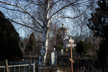 Christian cemetery with church. Sunny day and blue sky. Eternal memory and peace.