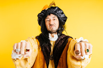 Man Dressed as Columbus With Rings on Finger Showing Fists Like a Boss