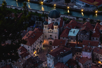 Kotor Old Town. Evening aerial view of Saint Nicholas Church with soft lighting accentuating its baroque architecture and terracotta roofs. Balkans, Montenegro