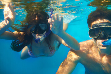 Scuba diving, underwater or couple swimming to explore for marine adventure, hobby or vacation...