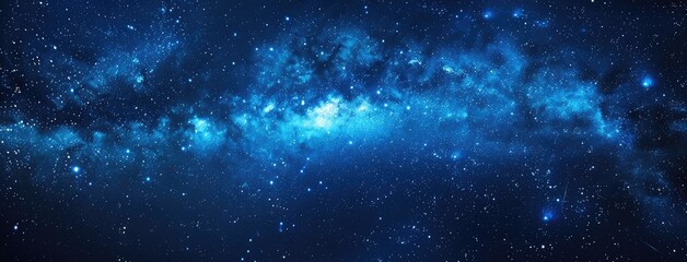 Fototapeta premium a panoramic night sky adorned with twinkling stars against a deep blue backdrop, perfect for creating a captivating starry background or celestial-themed banner.