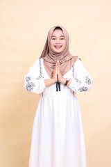 Portrait of a beautiful young Asian Muslim woman wearing a cheerful hijab posing to welcome Ramadan and Eid. for advertising, content, banners and Ramadan