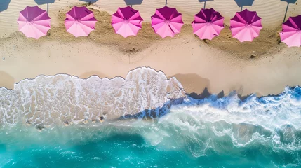 Rolgordijnen Beach with pink umbrellas, top view, drone photo, sea waves in the background, summer vacation concept © ALL YOU NEED studio
